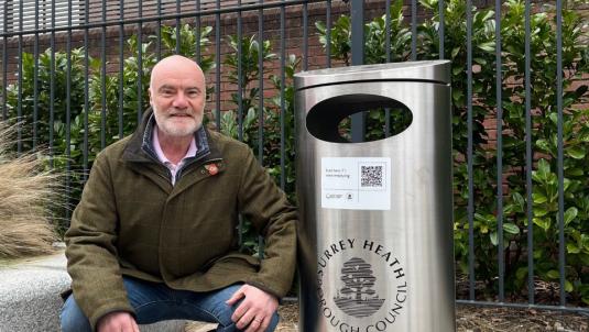 Councillor Colin Dougan next to a QR bin