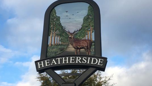 Heatherside sign with illustration of deer stag with avenue of trees