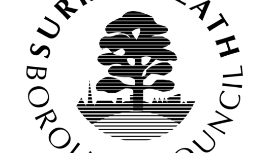 SHBC logo, black tree surrounded by the words Surrey Heath Borough Council in a circle