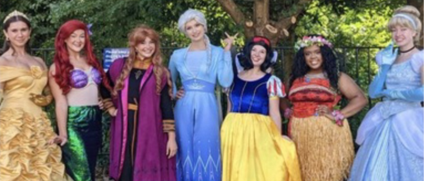 group of people dressed as Disney princesses