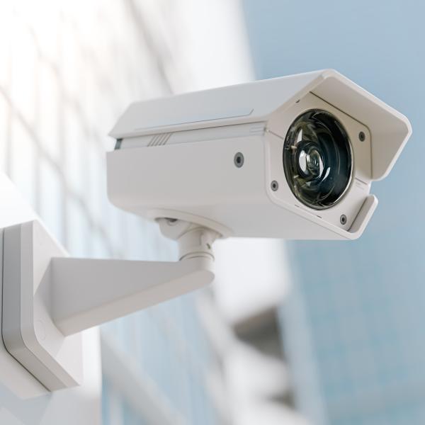 White CCTV camera on side of building